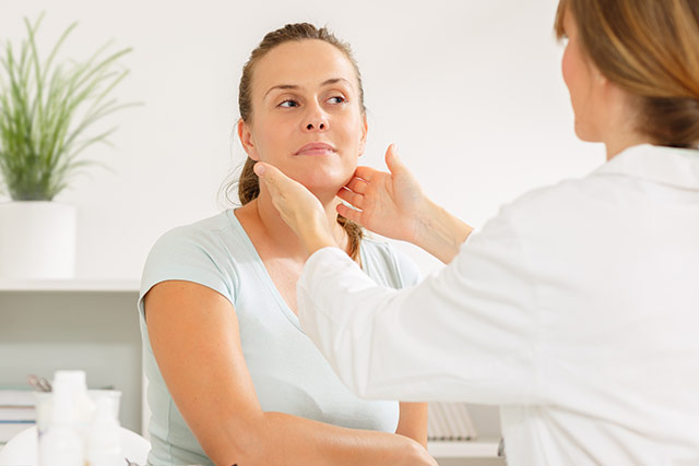 Doctor looking at female patients face