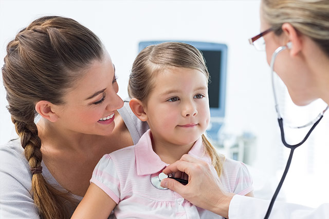 Doctor checking toddlers heart beat