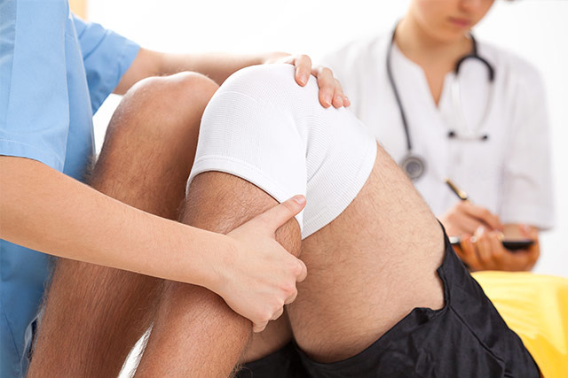 Doctor working on a man's knee